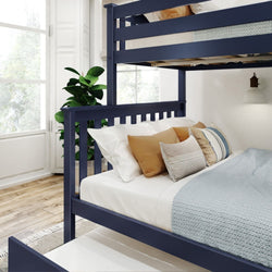 Modern navy blue bunk bed with cozy bedding and decorative pillows in a bright, stylish bedroom setting.