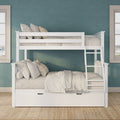 White wooden bunk bed with neutral linen bedding and ladder against a teal accent wall, natural jute rug and window light