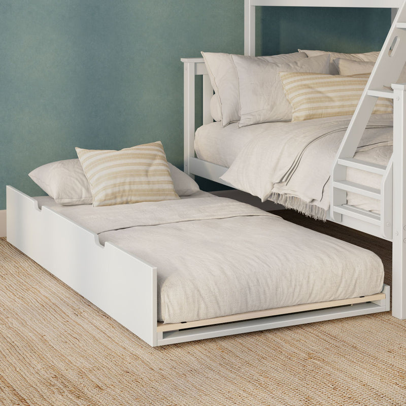 White wooden bunk bed with pull-out trundle, layered neutral linen bedding and beige striped pillows against a textured teal wall on a natural jute rug
