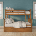 Solid wood twin-over-full bunk bed with ladder and under-bed storage drawer, neutral white linens and plaid accent pillows against a teal textured accent wall flanked by windows in a modern kids' bedroom