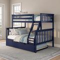 Navy blue twin-over-full bunk bed with built-in ladder and trundle, styled with blue floral pillows and coastal bedroom decor