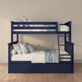 Navy blue wooden bunk bed with ladder and under-bed storage drawer, white and light-blue bedding and floral pillows on hardwood floor against a beige wall
