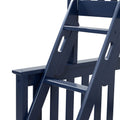 Close-up of navy blue wooden Adirondack-style chair armrest and slatted back, outdoor patio furniture
