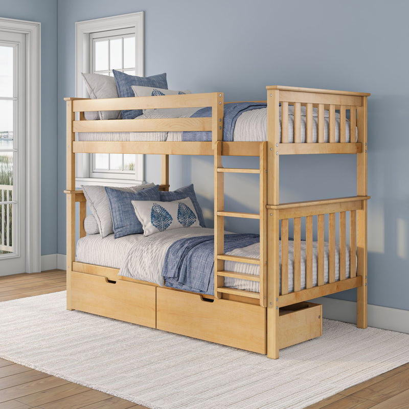 Solid maple twin-over-full bunk bed with ladder and under-bed storage drawers, styled with blue and gray coastal bedding and decorative pillows in a sunlit children's bedroom with light hardwood floors and large windows