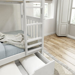 White wooden bunk bed with ladder, featuring storage drawer underneath and a cozy blue blanket, in a bright, modern bedroom with wooden flooring.