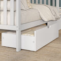 White wooden bunk bed with pull-out trundle and under-bed storage drawer, neutral linen bedding, beige throw and woven jute rug