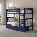 Navy blue wooden twin-over-twin bunk bed with ladder and underbed storage drawers in a coastal-style bedroom with blue and beige bedding and white window trim