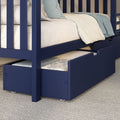 Navy blue wooden children's bunk bed with pull-out trundle drawer, cream mattress and light blue bedding on carpet