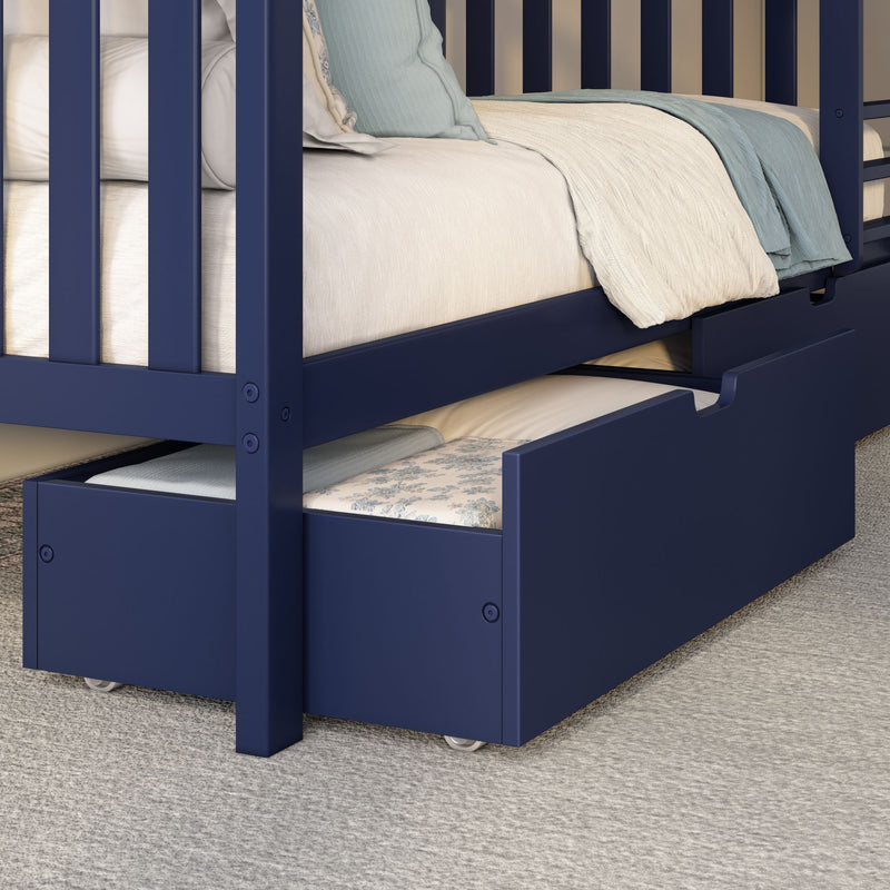 Navy blue wooden children's bunk bed with pull-out trundle drawer, cream mattress and light blue bedding on carpet