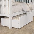 White wooden twin bunk bed with pull-out trundle drawer, neutral beige bedding and fringed throw on woven jute rug