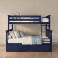 Modern navy blue wooden bunk bed with ladder and under-bed storage drawers, styled with white and blue bedding and floral pillows in a kids' bedroom