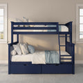 Navy blue wooden twin-over-full bunk bed with ladder, under-bed storage drawers and light blue floral pillows in styled kids' bedroom