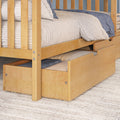 Light maple bunk bed with pull-out trundle and under-bed storage drawers, white quilted bedding and blue throw