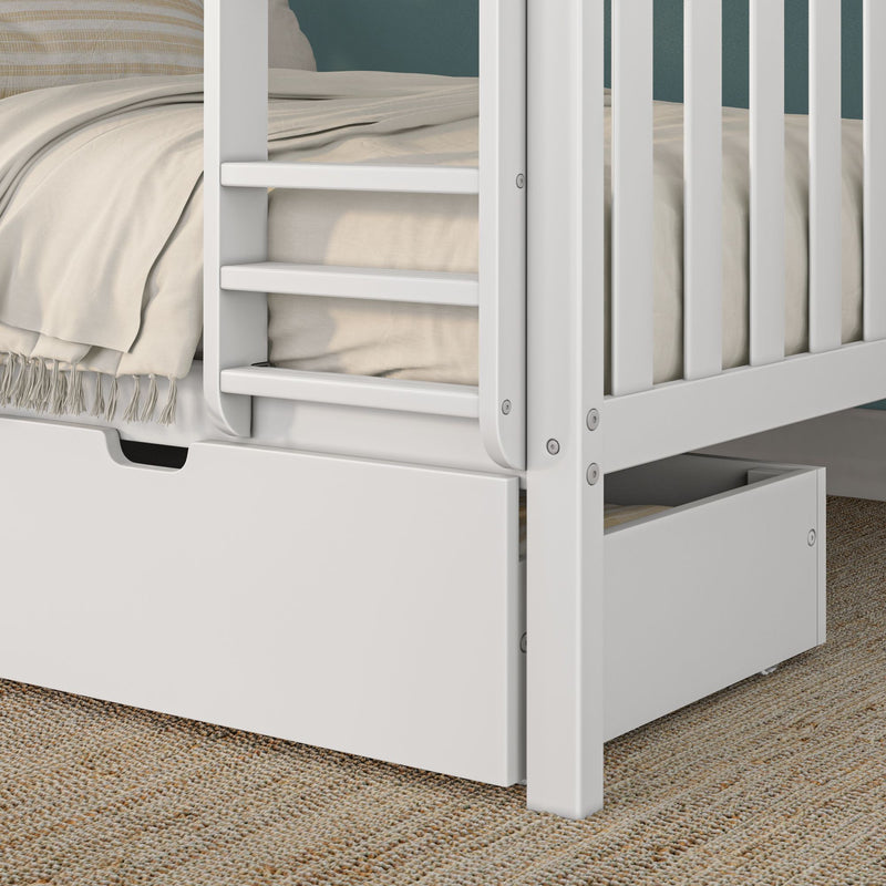 White wooden bunk bed with ladder and under-bed storage drawer, beige linen bedding and fringed throw on textured jute rug