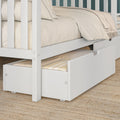 White wooden bunk bed with pull-out trundle drawer, beige linen bedding and throw on woven jute rug in children's bedroom