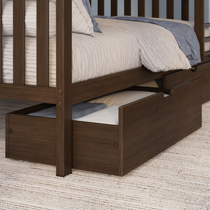 Solid wood bunk bed with pull-out trundle and storage drawer, white quilted bedding and blue blanket on brown frame over textured rug