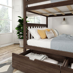 Elegant wooden bunk bed with pull-out drawer storage, white and yellow pillows, and cozy blue bedding in a sunlit modern bedroom.