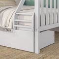 White wooden bunk bed ladder and safety rail with neutral linen bedding and built-in drawer on woven jute rug