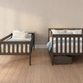 Two dark wood twin beds with blue floral pillows and light bedding in a cozy neutral bedroom with hardwood floors