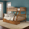 Solid wood twin-over-full bunk bed with ladder and under-bed storage drawers in a coastal teal bedroom with neutral linens and pillows