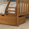 Close-up of solid wood bunk bed ladder and slatted guardrail with under-bed storage drawer in natural oak finish, beige linen bedding on woven rug