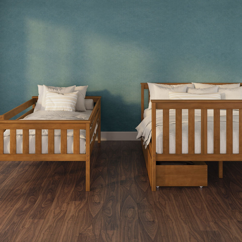 Two wooden twin beds with white bedding against a teal textured wall on dark hardwood floors, minimalist children’s bedroom nursery interior