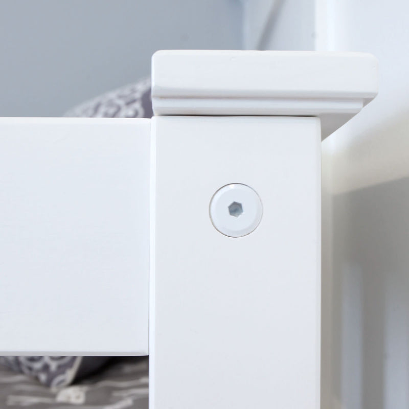 Close-up of a white wooden bed frame corner with assembly bolt, highlighting sturdy construction.