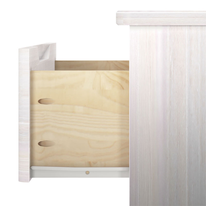 Wooden drawer partially open in a light-colored dresser.