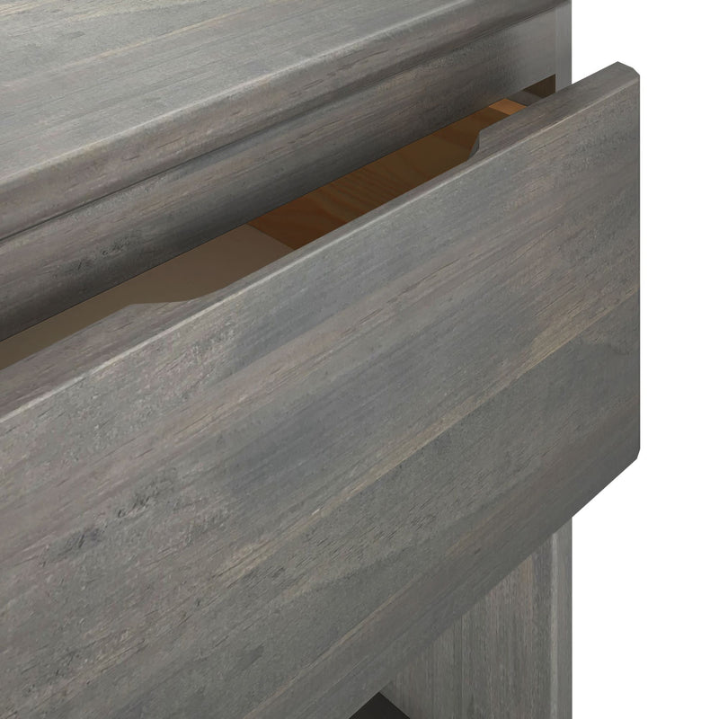 Gray wooden open drawer showcasing storage space in a modern furniture design.