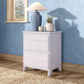 Bedroom decor scene with whitewashed bedside table, blue ceramic table lamp, textured blue wallpaper, potted plant and natural wood window frame