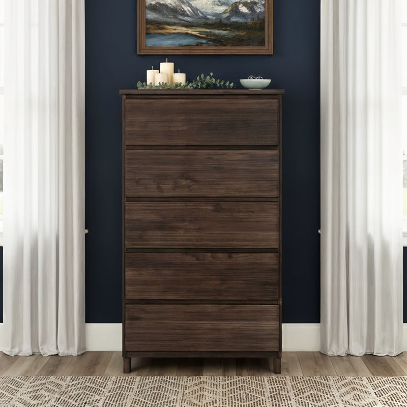 Tall dark walnut five-drawer dresser in modern bedroom with navy blue wall, white curtains, framed landscape art, decorative candles and wood floor rug