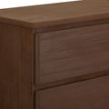 Natural wood texture dresser corner with smooth surface and minimalist design.