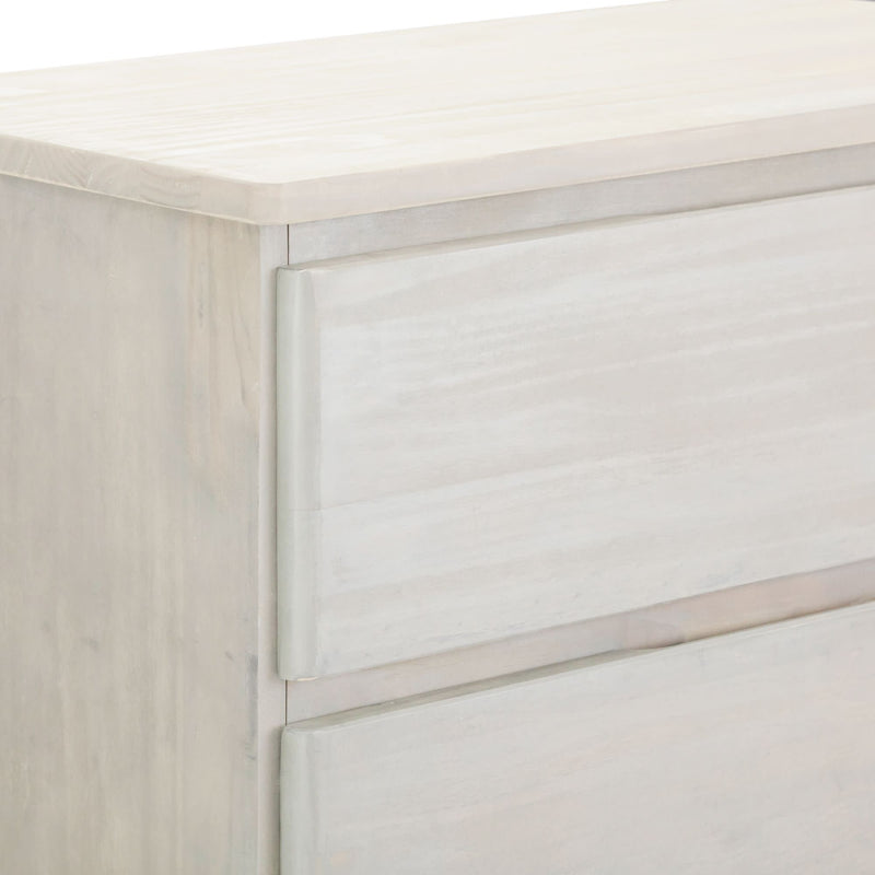 White wooden chest of drawers showing top corner detail, minimalist bedroom furniture design.