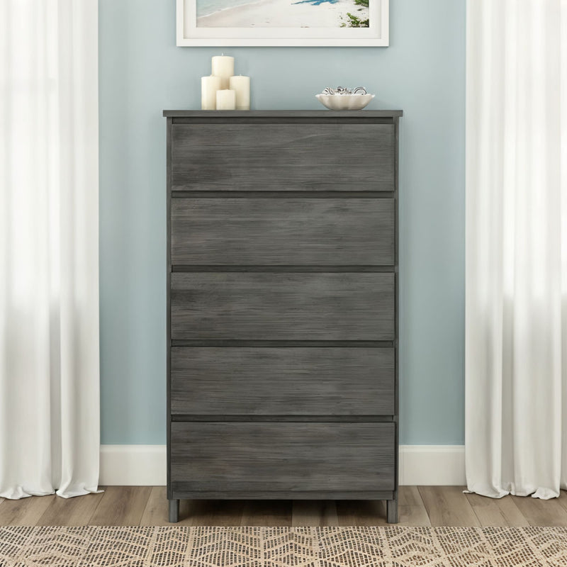 Gray wood 5-drawer tall dresser for bedroom storage, modern coastal-style decor with pale blue wall, white curtains, candles and decorative bowl on top