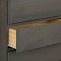 Wooden dresser with partially opened drawer in modern design.