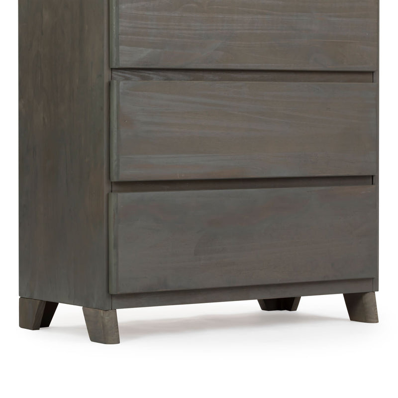 Dark wooden dresser with three drawers and short legs.