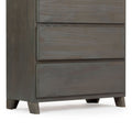 Dark wooden dresser with three drawers and short legs.