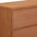 Close-up view of a wooden dresser with a smooth finish and modern design.