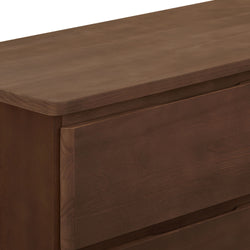 Close-up of dark brown solid wood dresser drawers with recessed handles and smooth matte finish, modern bedroom furniture