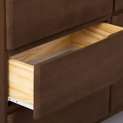 Close-up of an open brown wooden dresser drawer with light pine interior, smooth modern front panel and metal slide, ideal for bedroom storage