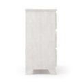 Side view of a white wooden three-drawer dresser with a whitewashed finish on a white background
