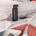 Wooden bed shelf with black water bottle and smartphone, bunk bed organizer for bedroom storage.