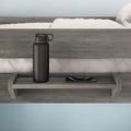 Black water bottle and smartphone on a wooden bed shelf in a modern bedroom.