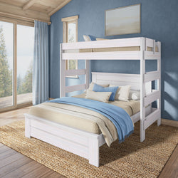 White wooden twin-over-full bunk bed with blue linens in coastal-style bedroom, natural wood floors, woven rug and large windows overlooking trees