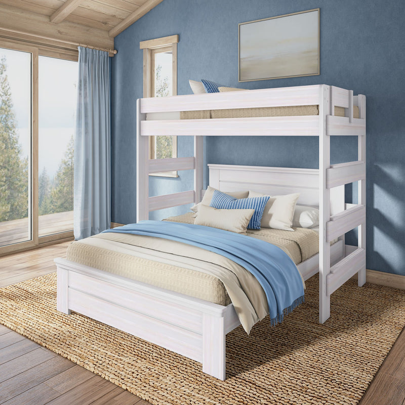 White wooden twin-over-full bunk bed with blue linens in coastal-style bedroom, natural wood floors, woven rug and large windows overlooking trees