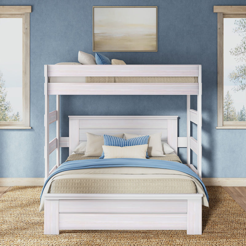 White wooden bunk bed in coastal blue bedroom with layered blue and beige bedding, striped accent pillows, woven jute rug and framed wall art