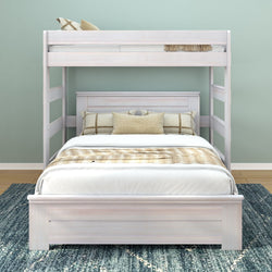 Stylish white bunk bed with comfortable pillows and bedding in a modern bedroom setting.
