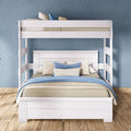 White wooden two-level bunk bed with blue and beige bedding in a modern kids' bedroom, space-saving design on hardwood floor