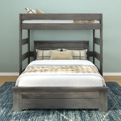 Gray wooden bunk bed with twin and full-size mattresses, white bedding, and decorative pillows, in a modern bedroom setting with a blue rug.