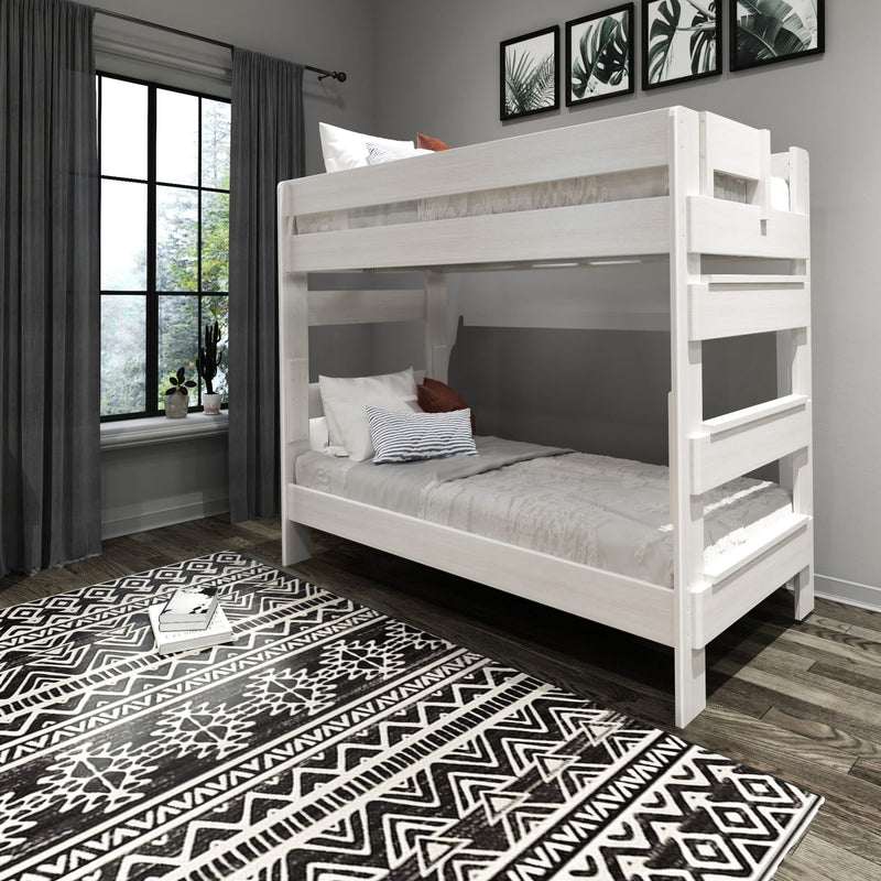 White bunk bed in modern bedroom with patterned rug and large window.